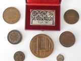 an assortment of coins including a medal, a medal, and a medal