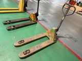 three forklifts sitting on the floor in a warehouse