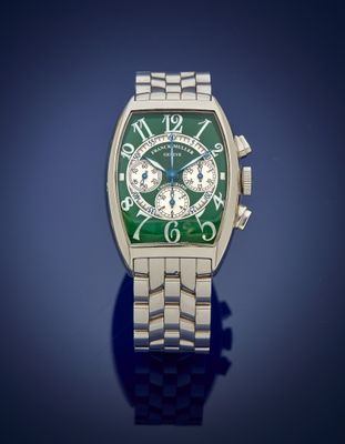 a close up of a watch with a green face on a blue background
