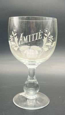 an empty wine glass sitting on a table