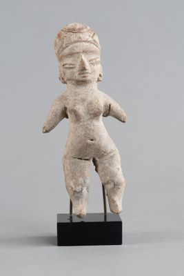 une petite statue représentant une femme tenant un bébé dans ses bras, posée sur un socle noir