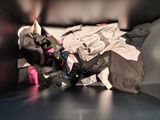 a pile of clothing on a table next to a pair of shoes