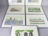 four framed pictures of a city with buildings and trees on them