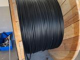 a spool of black wire on a wooden spool