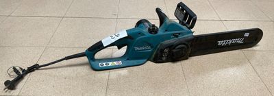 a blue corded saw on the floor with a tag attached to it