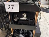 several hair dryers are stacked on top of a cart in a store