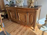 a wooden cabinet with a clock on top of it in a room
