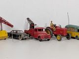 several toy cars are lined up in a row on a white surface