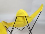 pair of yellow folding chairs with black legs on white background