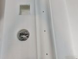 a white box that has a sink and a faucet in it