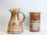 two brown vases sitting next to each other on a table