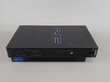 a close up of a sony playstation game console on a white surface