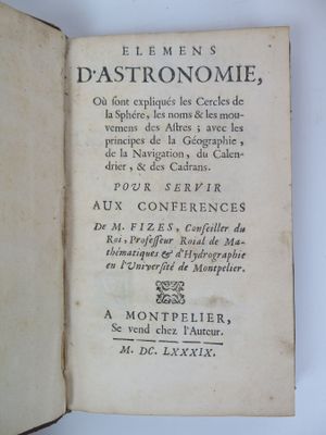 an old book with writing on it sitting on a table