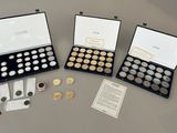 four different types of coins are displayed in a display case