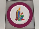 a plate with a colorful design on it in a box