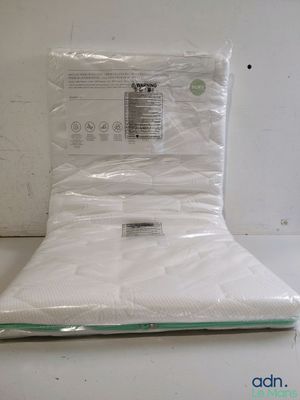 a close up of a mattress in a plastic bag on a table
