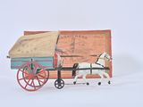 a toy horse pulling a wagon with a cart attached to it