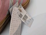 a pink pair of shoes with a price tag on it