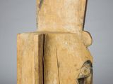 an image of a wooden sculpture of a man ' s head on top of a wooden block