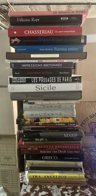 many books stacked on top of each other on a table