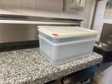 a plastic container sitting on a counter in a kitchen