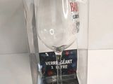 a wine glass in a clear plastic box on a table