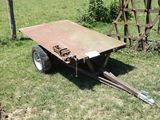 a trailer that is sitting in the grass in the yard