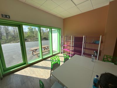 a room with a table, chairs, and a bench in it
