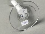 a wine glass with a label on it sitting on a table