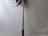 an orange and black pole with a magazine holder attached to it ' s side