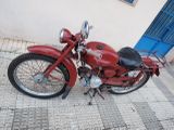 a red motorcycle parked on the side of the street