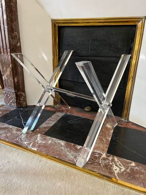 a large mirror on the floor in front of a fireplace