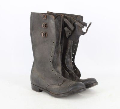 pair of vintage black leather boots on white background