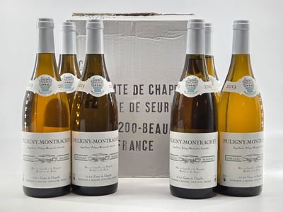 three bottles of white wine sitting next to each other in front of a box