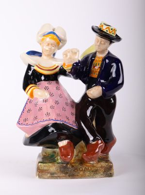 a figurine of a man and a woman sitting on a bench