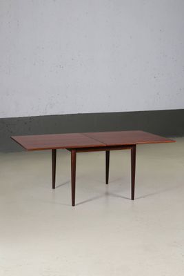 the table is made of wood and has a rectangular top