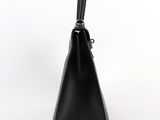 black leather handbag on a white background with a black handle