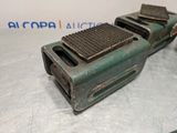 an old green machine that is sitting on a table