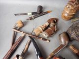 many different types of smoking pipes on the table