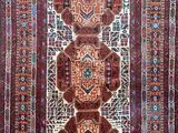 an oriental rug with four medallions on a red ground