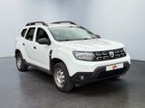 the white dacia is parked in a room with a black floor