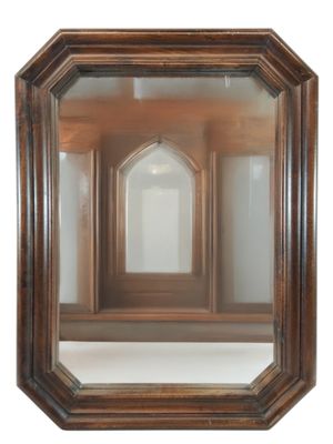 a mirror that has a reflection of a building in it