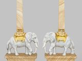 pair of white and gold elephant lamps on wooden bases