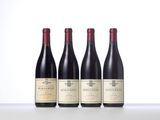 three bottles of wine are lined up on a table
