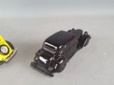 two toy cars sitting next to each other on a table