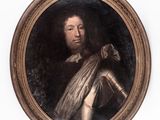 portrait of a man in armor in a gold oval frame