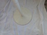 a white umbrella that is sitting on a white sheet