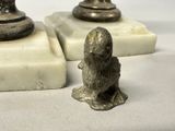 two figurines that are sitting next to each other