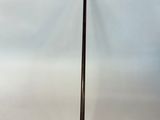 the handle of an umbrella is made of metal and has a long handle