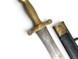 a knife that is sitting on a table next to a knife